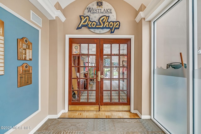 entryway with french doors, parquet flooring, and lofted ceiling