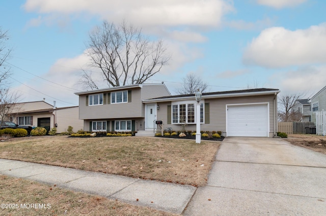 split level home with a garage and a front yard