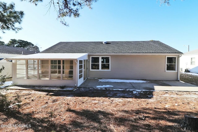 rear view of property featuring a sunroom and a patio area