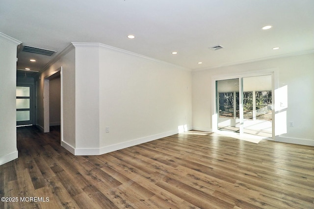 unfurnished room with ornamental molding and dark wood-type flooring