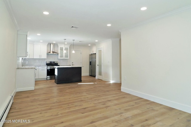 kitchen featuring appliances with stainless steel finishes, wall chimney exhaust hood, baseboard heating, a center island, and white cabinetry