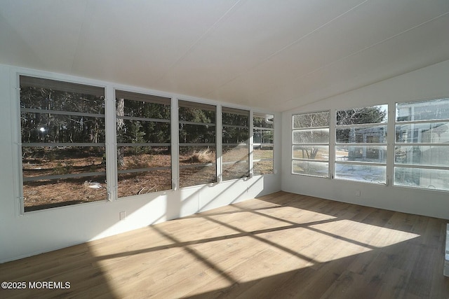 unfurnished sunroom with lofted ceiling