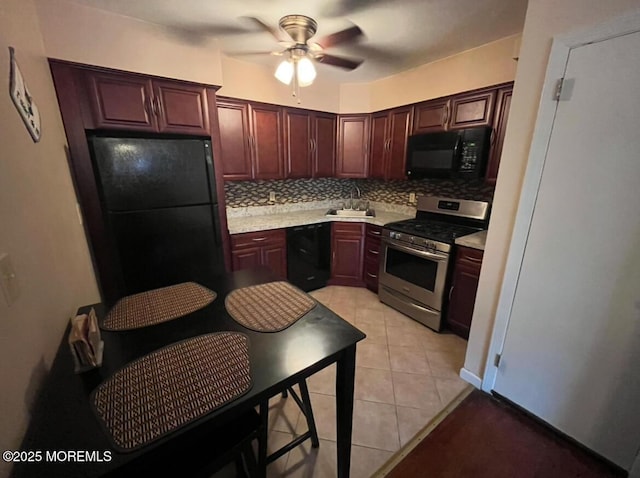 kitchen with light tile patterned flooring, tasteful backsplash, ceiling fan, and black appliances