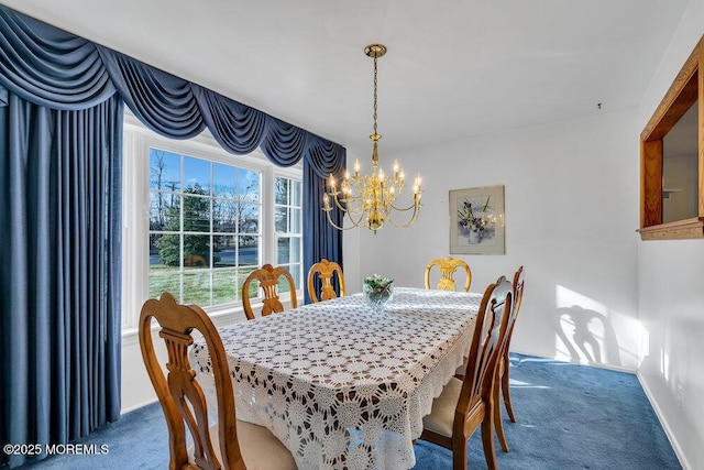 dining space featuring dark colored carpet and an inviting chandelier