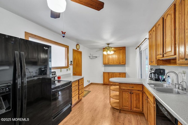 kitchen with black appliances, sink, light hardwood / wood-style flooring, ceiling fan, and tasteful backsplash