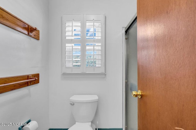 bathroom with walk in shower and toilet