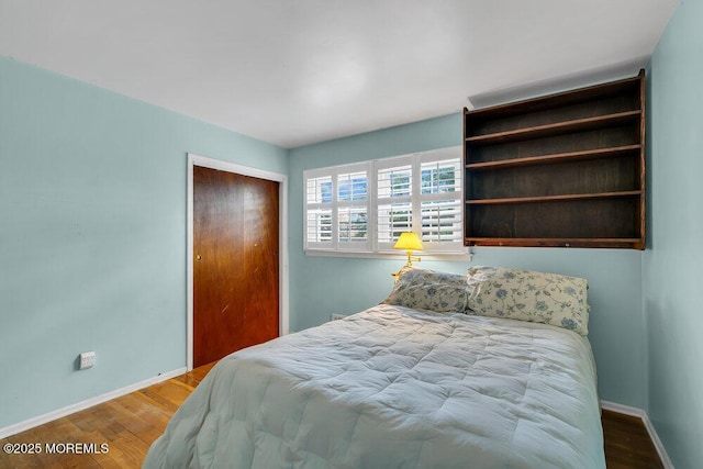 bedroom featuring hardwood / wood-style floors and a closet