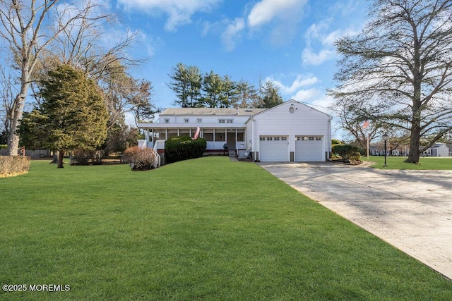 view of front of property with a garage and a front lawn