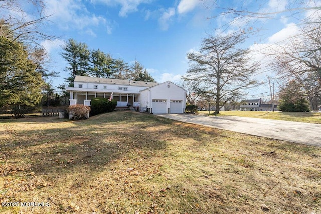 view of front of property with a front lawn and a garage