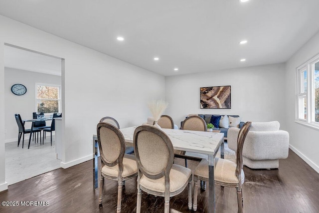 dining space with dark hardwood / wood-style flooring