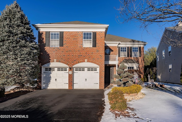 view of property with a balcony and a garage