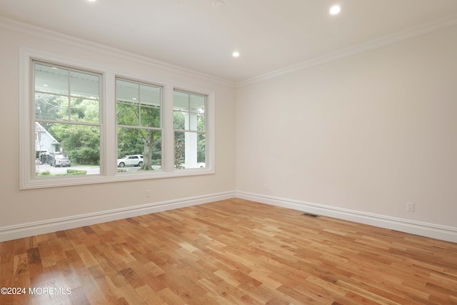 unfurnished room with light hardwood / wood-style floors and ornamental molding