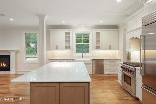 kitchen with white cabinets, a kitchen island, and high quality appliances