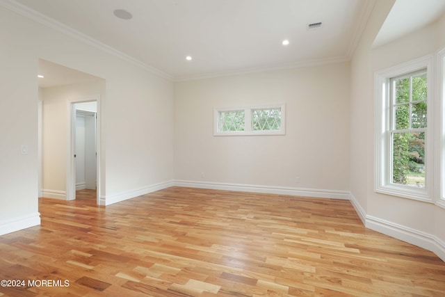 unfurnished room featuring light hardwood / wood-style floors and ornamental molding