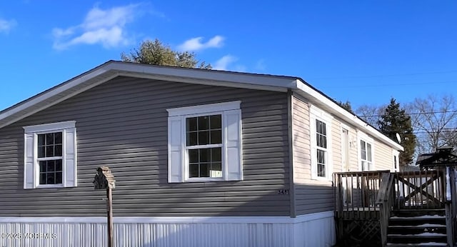 view of home's exterior featuring a wooden deck