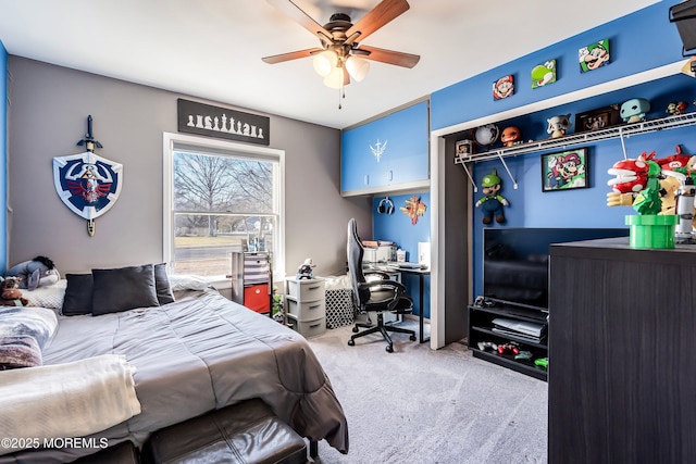 bedroom with ceiling fan, light colored carpet, and a closet