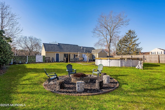 view of yard with an outdoor fire pit