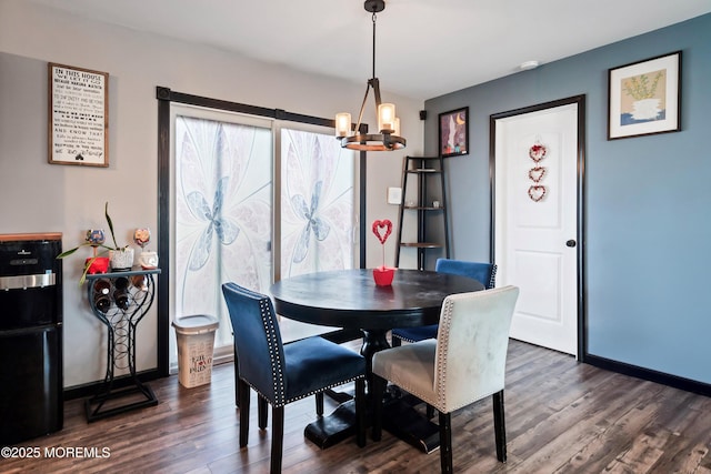 dining area featuring dark hardwood / wood-style flooring and an inviting chandelier