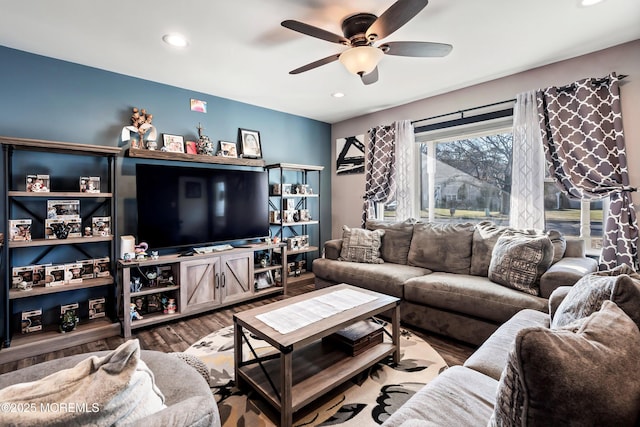 living room featuring ceiling fan and hardwood / wood-style flooring