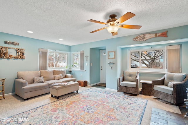 living room with ceiling fan and a textured ceiling