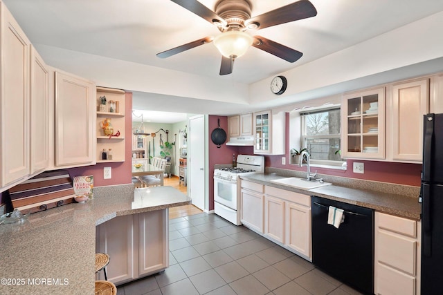 kitchen with kitchen peninsula, ceiling fan with notable chandelier, sink, black appliances, and light tile patterned flooring