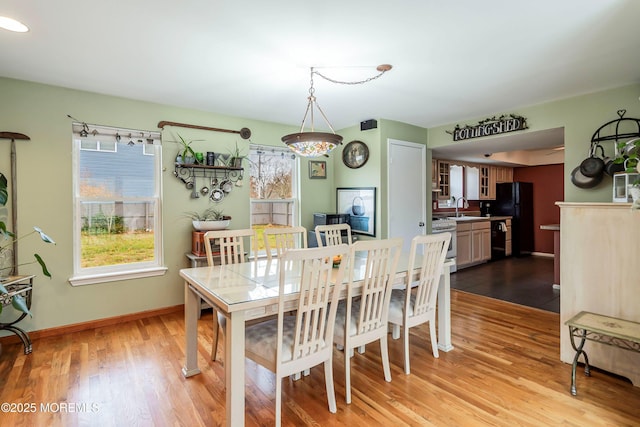 dining room with light wood-type flooring and sink