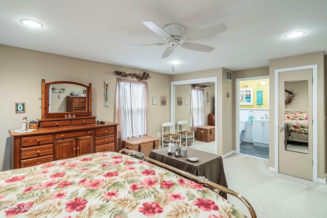 bedroom with light carpet, ensuite bathroom, ceiling fan, and sink