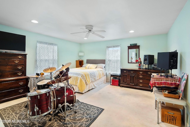 bedroom featuring light colored carpet and ceiling fan