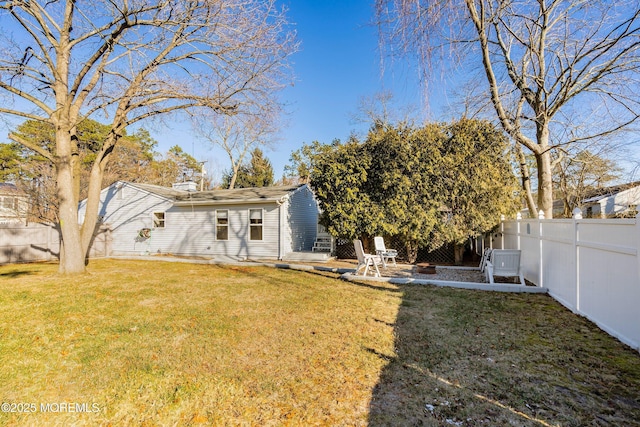 back of house with a yard and a patio