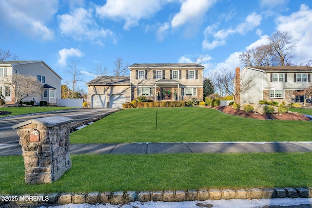 view of front facade featuring a front yard and a garage