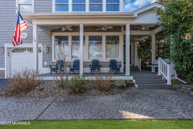 doorway to property with a porch, ceiling fan, and a garage