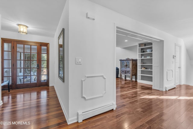 foyer with dark hardwood / wood-style flooring and a baseboard heating unit