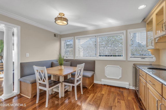 dining space featuring a baseboard radiator, ornamental molding, plenty of natural light, and dark hardwood / wood-style floors