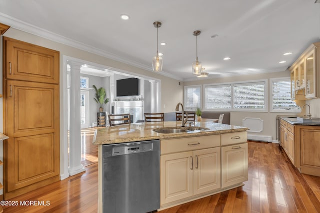 kitchen with a kitchen island with sink, ornate columns, crown molding, sink, and black dishwasher