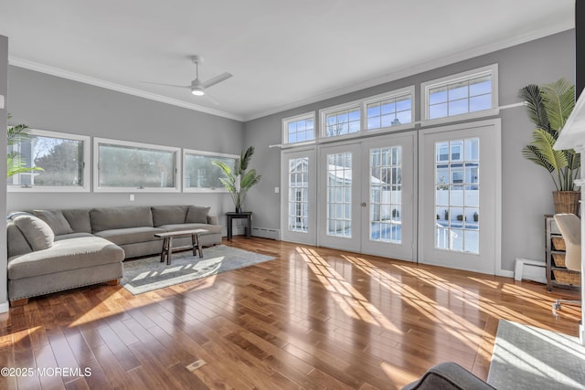 living room with french doors, hardwood / wood-style floors, baseboard heating, ornamental molding, and ceiling fan