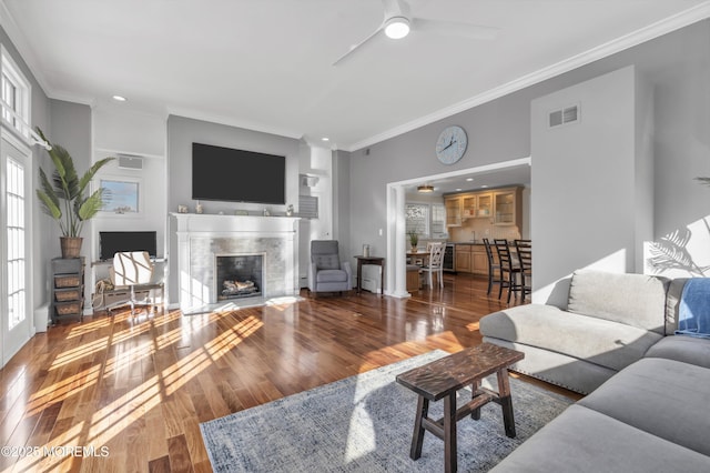 living room with ceiling fan, hardwood / wood-style flooring, and ornamental molding