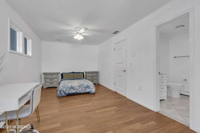 bedroom featuring ensuite bathroom, ceiling fan, and light hardwood / wood-style flooring