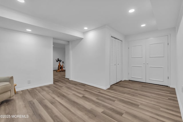 interior space with light wood-type flooring and crown molding