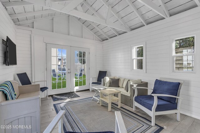 interior space featuring wood ceiling, french doors, wooden walls, and beamed ceiling