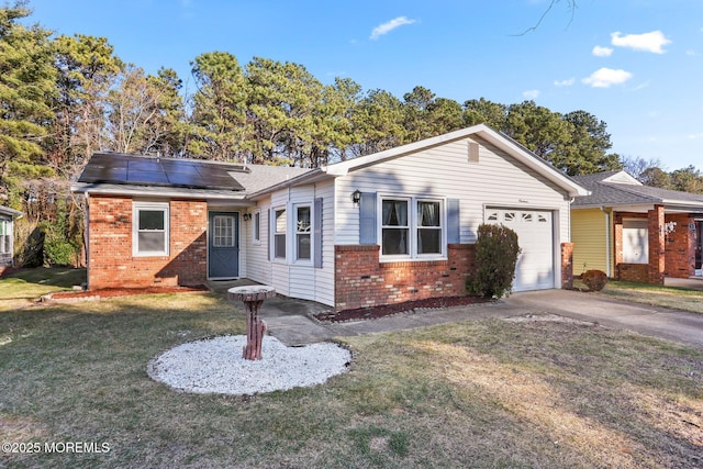 ranch-style house featuring solar panels, a garage, and a front lawn