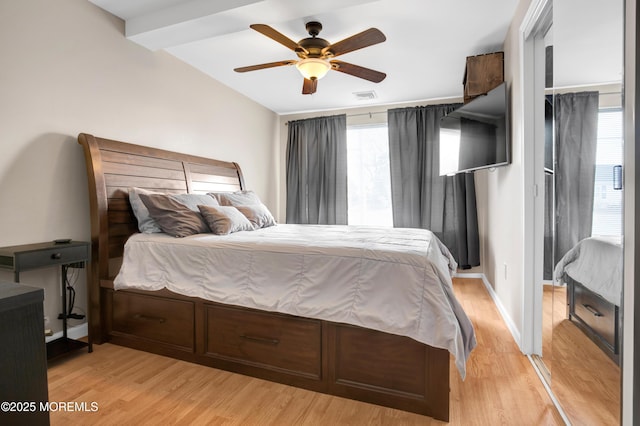 bedroom with vaulted ceiling, light hardwood / wood-style flooring, and ceiling fan