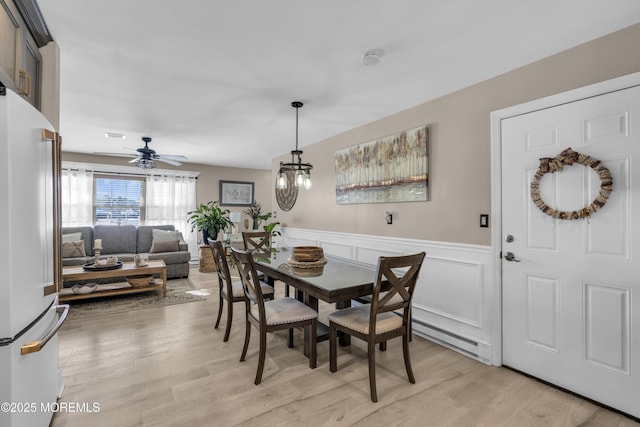 dining space featuring ceiling fan and light hardwood / wood-style floors