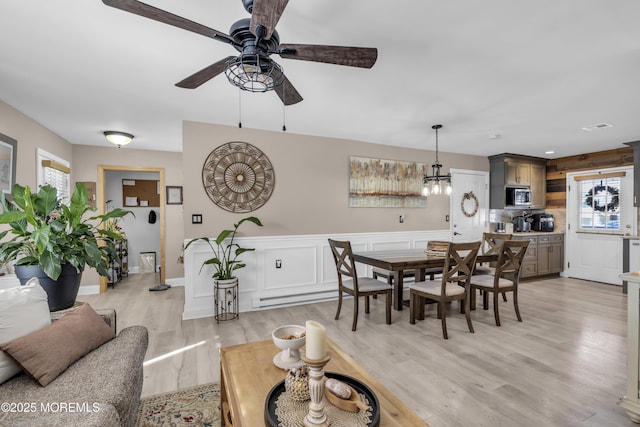 dining space featuring ceiling fan, light hardwood / wood-style floors, and a wealth of natural light