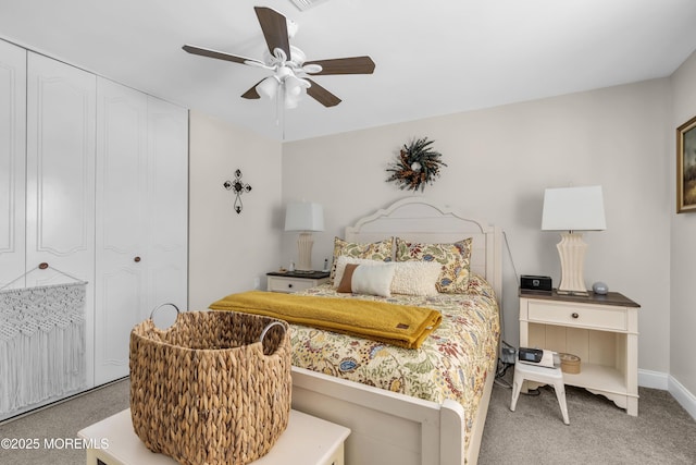 carpeted bedroom featuring ceiling fan and a closet