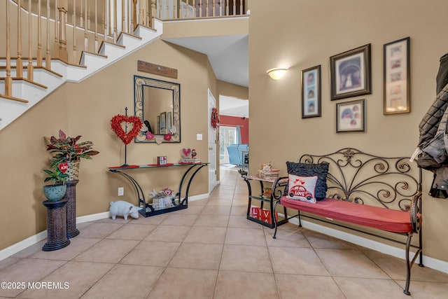 tiled entryway with a high ceiling