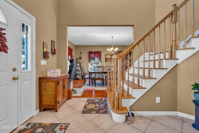 foyer with a notable chandelier and light tile patterned flooring