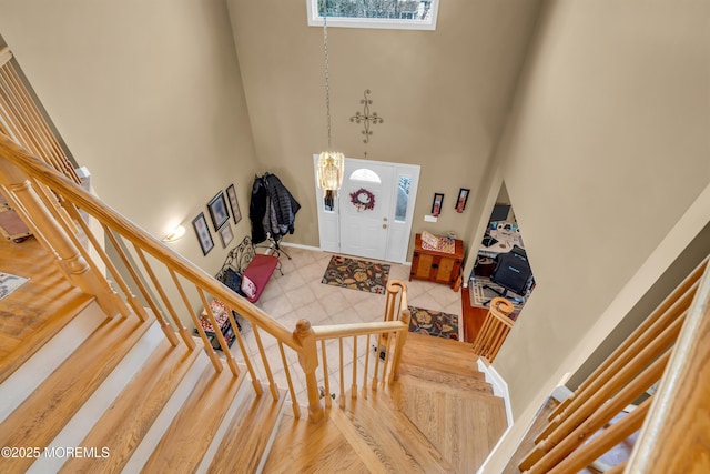 foyer featuring a high ceiling and a chandelier