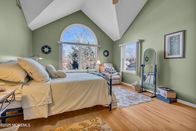 bedroom with vaulted ceiling and hardwood / wood-style flooring