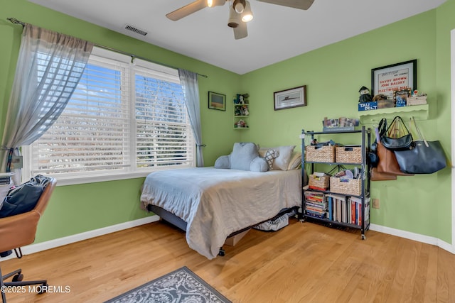 bedroom with ceiling fan and wood-type flooring