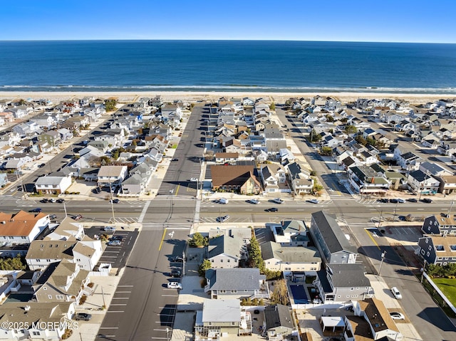 birds eye view of property with a water view and a view of the beach